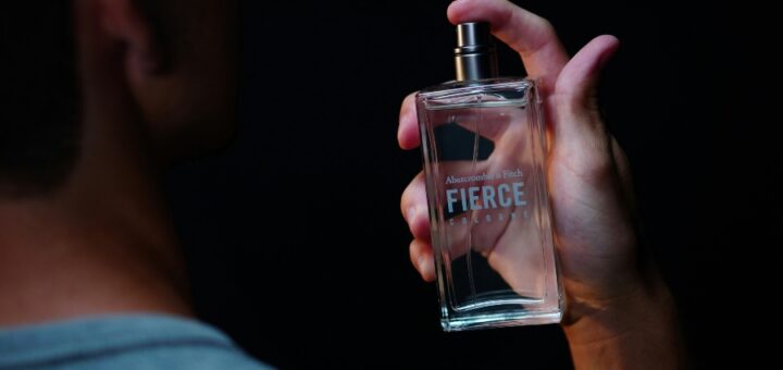 muskarac drzi u ruci parfem